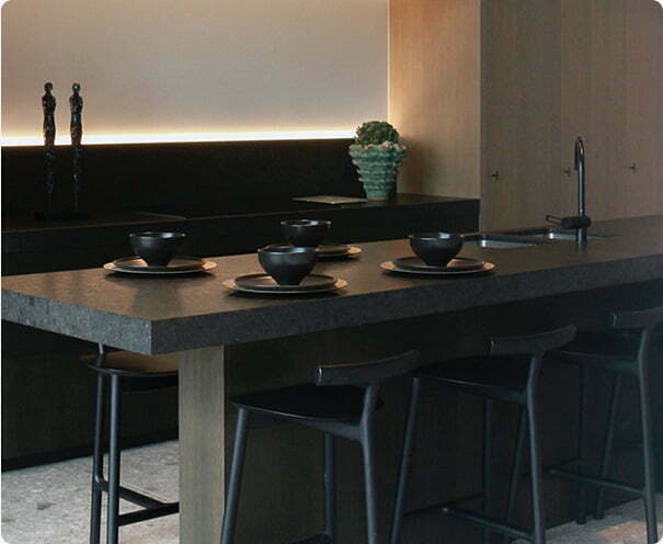 Kitchen with and island and bar stools with black granite worktop