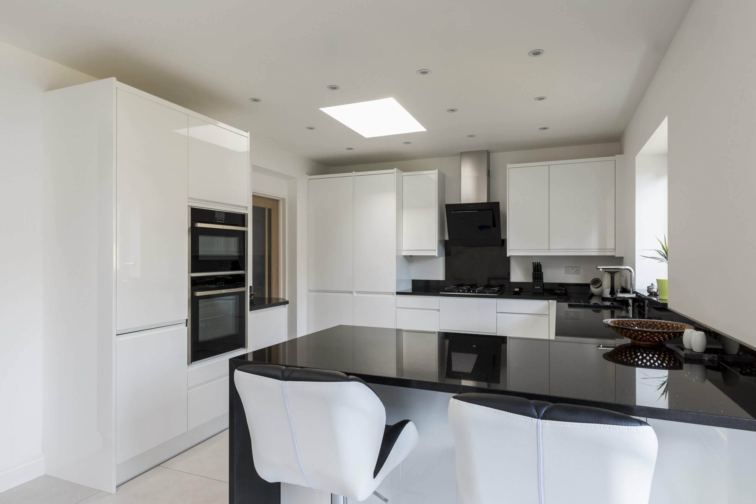 White kitchen deals with black granite